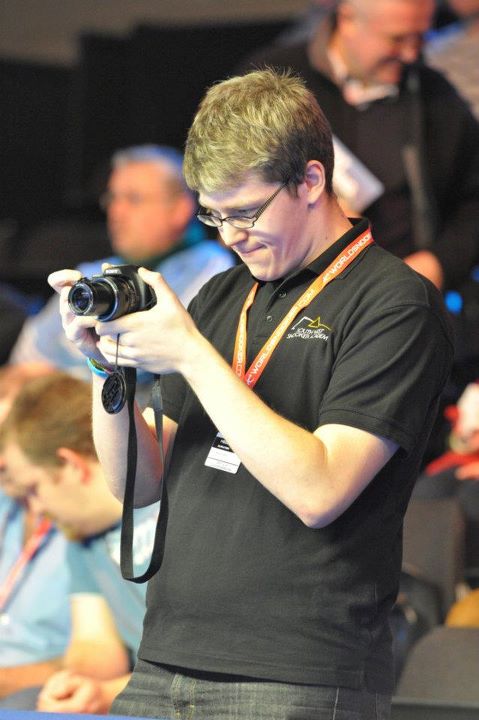 Steve Kent taking photos captured by Monique Limbos